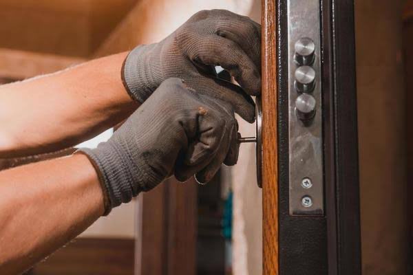 Locksmith working on door
